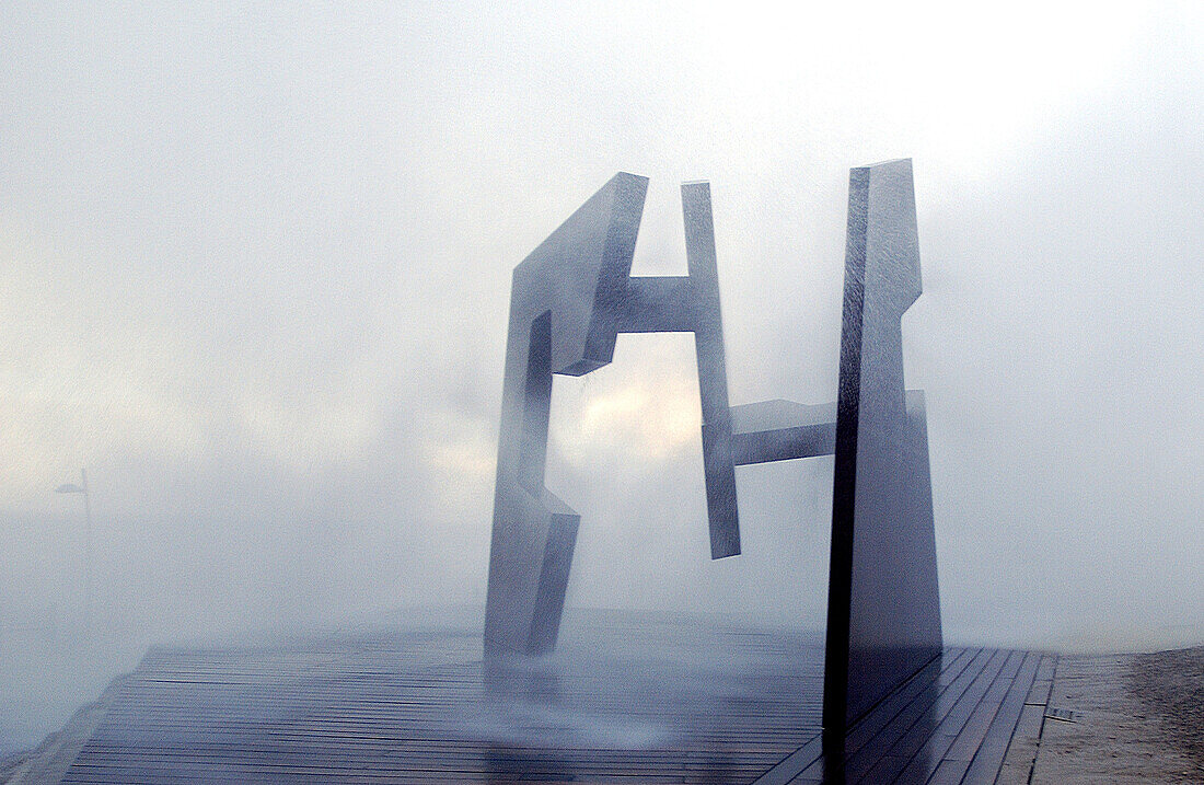 Sculpture by Jorge Oteiza and waves at Paseo Nuevo promenade. San Sebastián. Euskadi. Spain