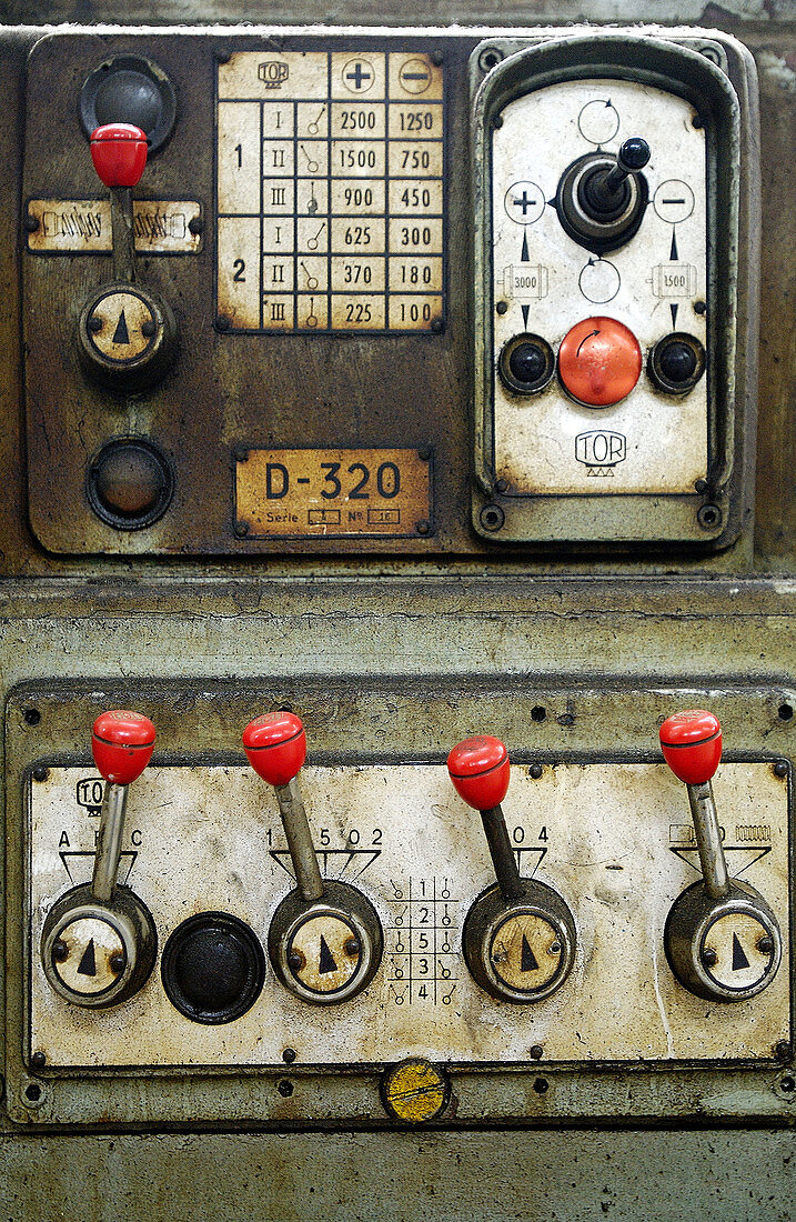 Controls of an old lathe machine.