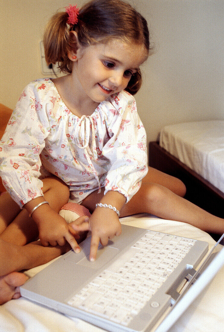 Child and laptop computer