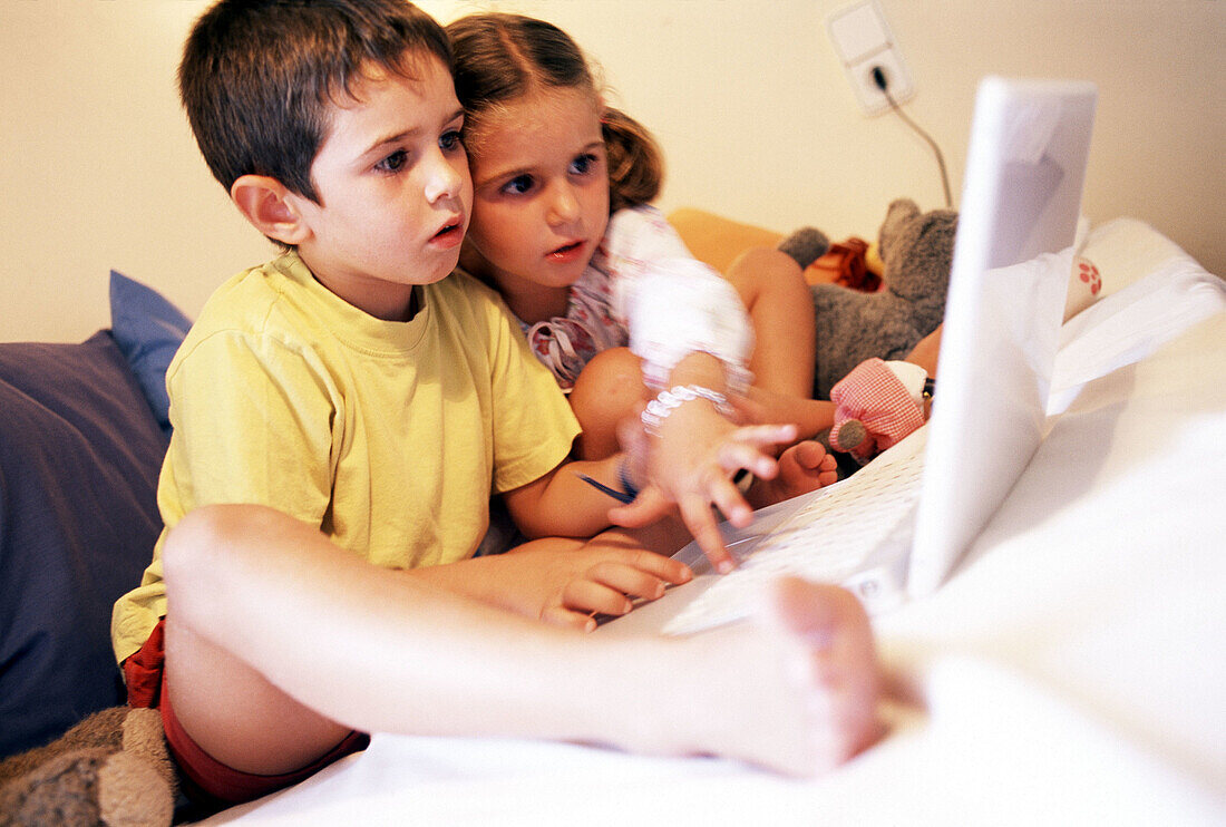 Children and laptop computer