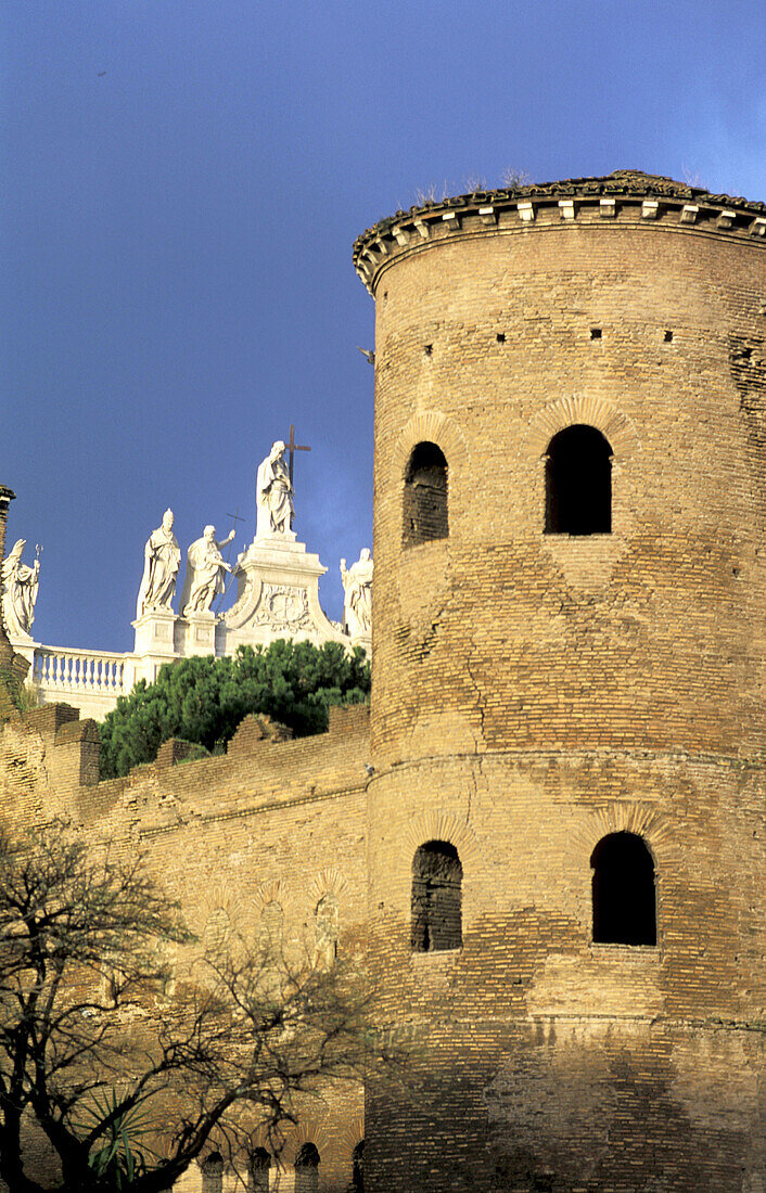 Detail of ramparts and Saint John Lateran basilica in background. Rome. Italy