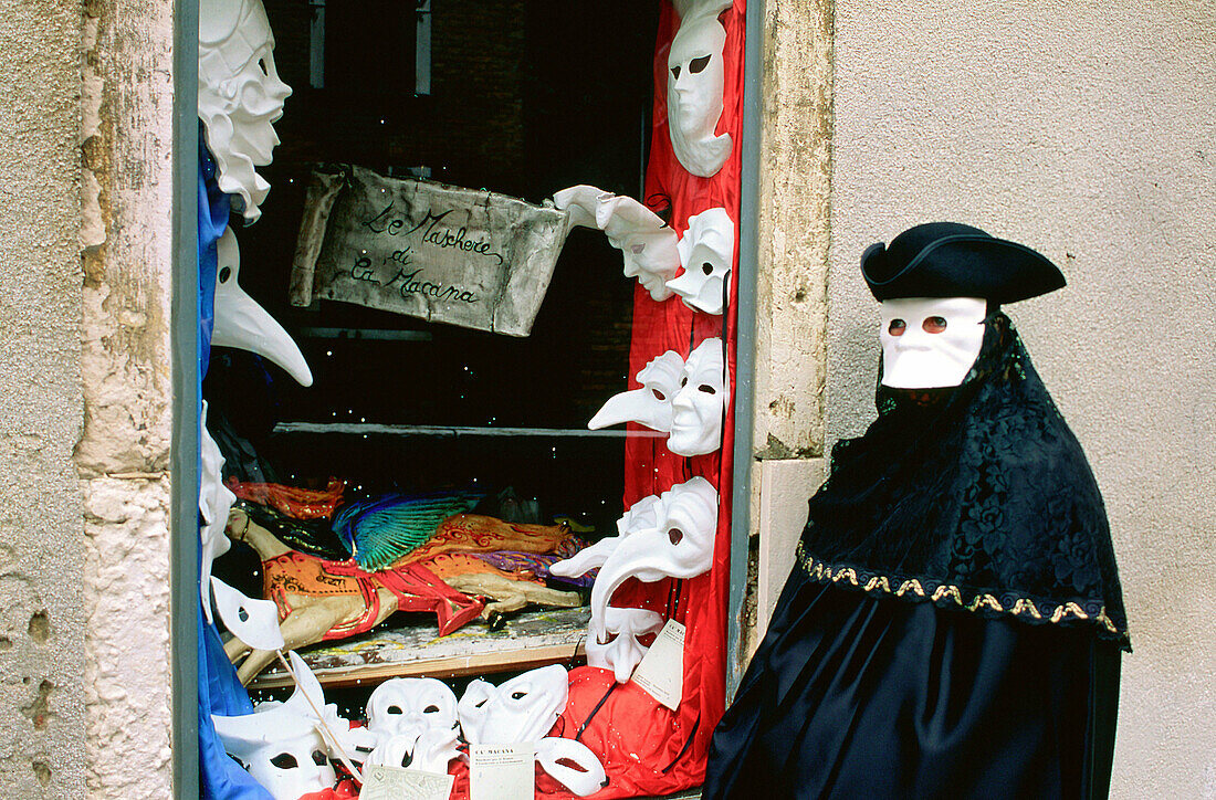 Masked man at masks shop window. Venice. Italy