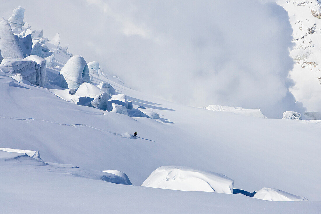 Skier in deep snow, Heliskiing, Kamchatka Peninsula, Sibiria, Russia