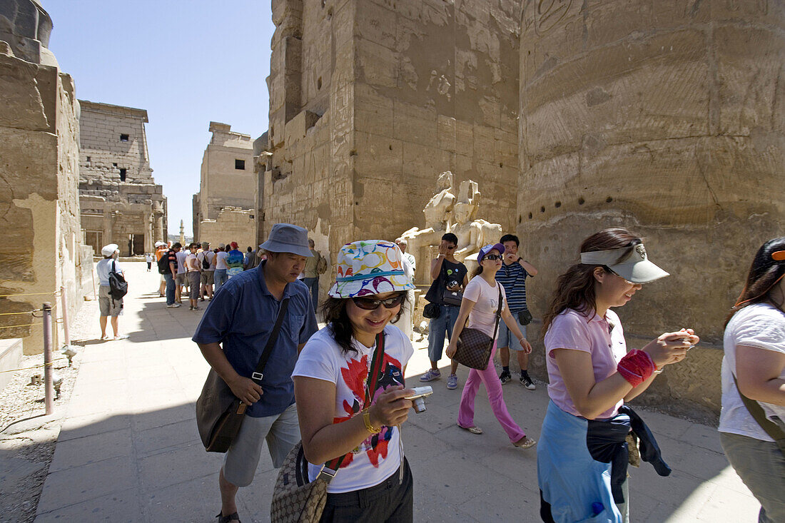 Tourists visiting. Consecrated to God Amon-Re the Luxor temple was built by Amenophis III (1391-1353) , elarged later on mostly by Ramasses II (1279-1213). The temple was linked to Karnak by a 3km alley lined with sphinxes. Luxor. Egypt