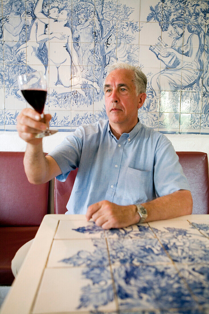 Famous photographer Kevin O Hara visiting Portugal and having a break at a typical cafe decored with azulejos . Lagoa. Algarve. Portugal