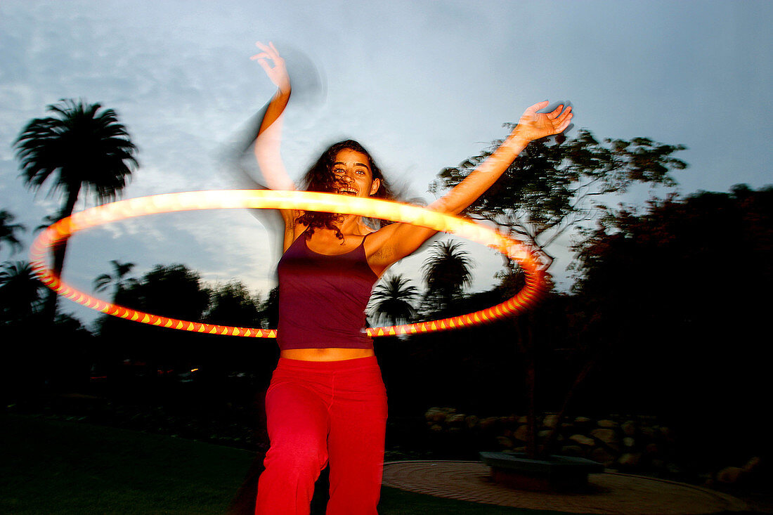 nt, Arms raised, Brunette, Brunettes, Carefree, Caucasian, Caucasians, Color, Colour, Contemporary, Dark-haired, Dusk, Exterior, Female, Fun, Girl, Girls, Horizontal, Hula hoop, Hula hoops, Hula-hoop