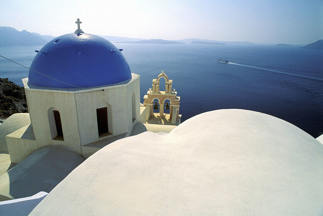 White washed cupola and blue Church belfry. Ia village. Santorini (Cyclades). Greece