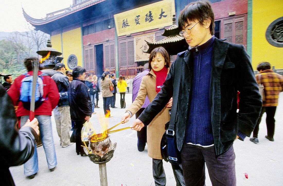 Ritual of burning incense sticks at temple. Hangzhou. Zhejiang province, China