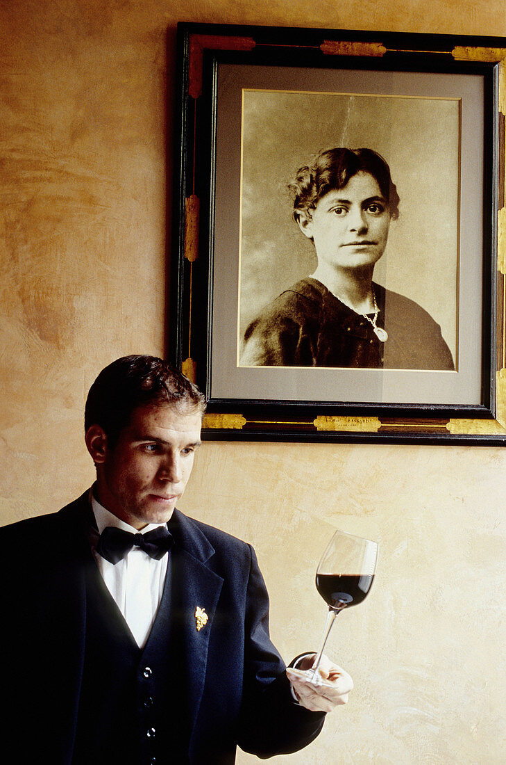 Wine waiter deputy under portrait of Alain Passard s grandmother. Restaurant L Arpege, Rue de Varenne. Owner and chef Alain Passard one of France most acclaimed chefs (three stars in Guide Rouge Michelin). Paris. France