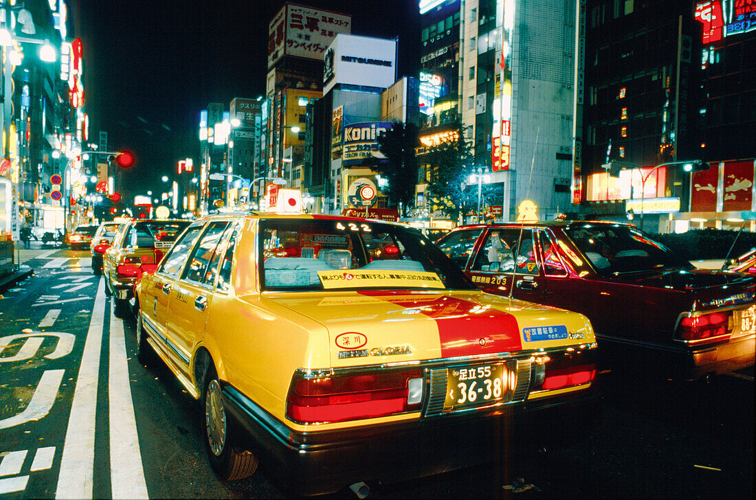 Taxis stuck in traffic, Shinjuku district at night. Tokyo, Japan