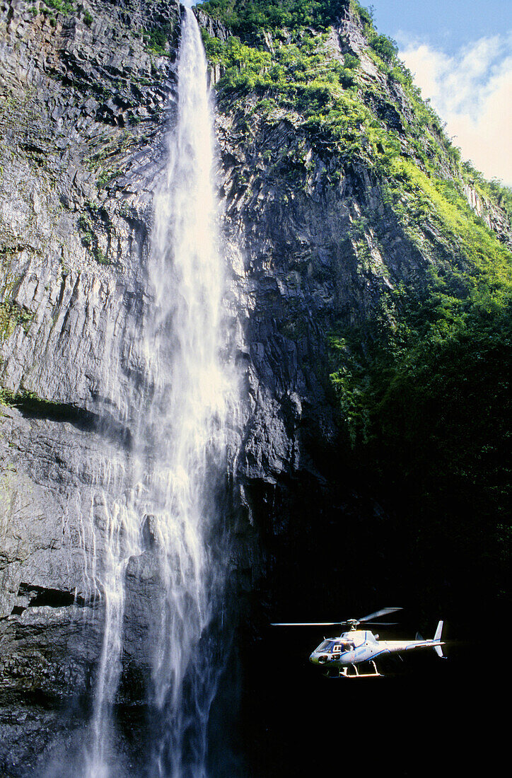 Helicopter by Trou de Fer cascading waterfall. Réunion Island (France)