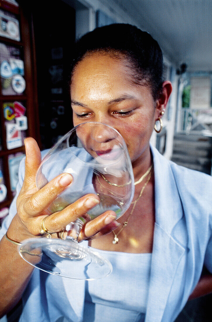 Woman tasting rum. Hell-Bourg, Salazie cirque. Réunion Island (France)
