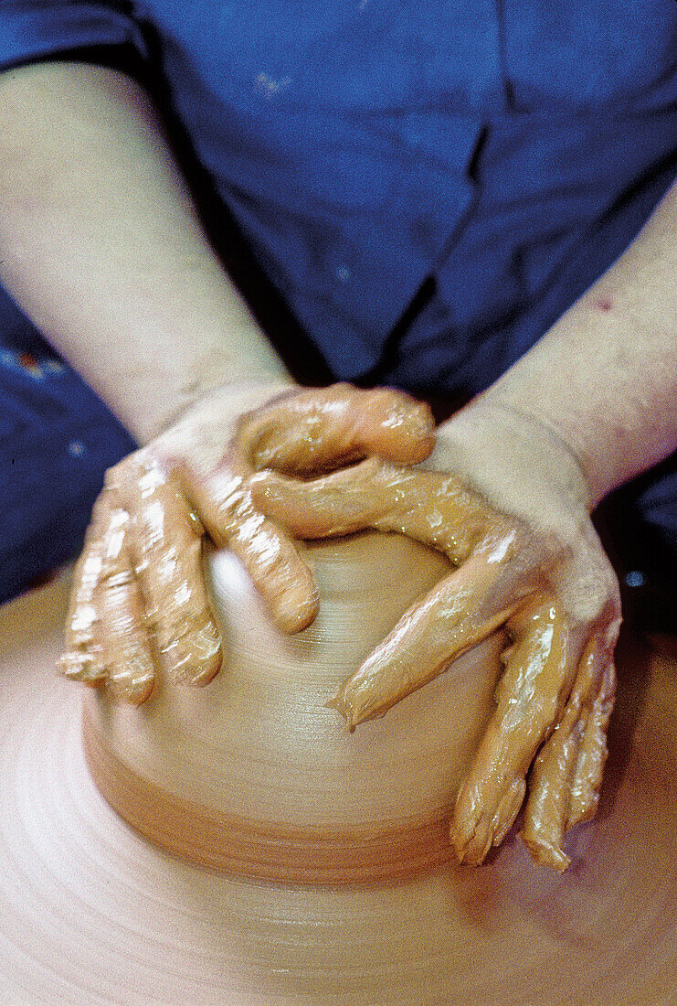 Close up on a traditional potter hands at work. Okinawa Island. Japan.