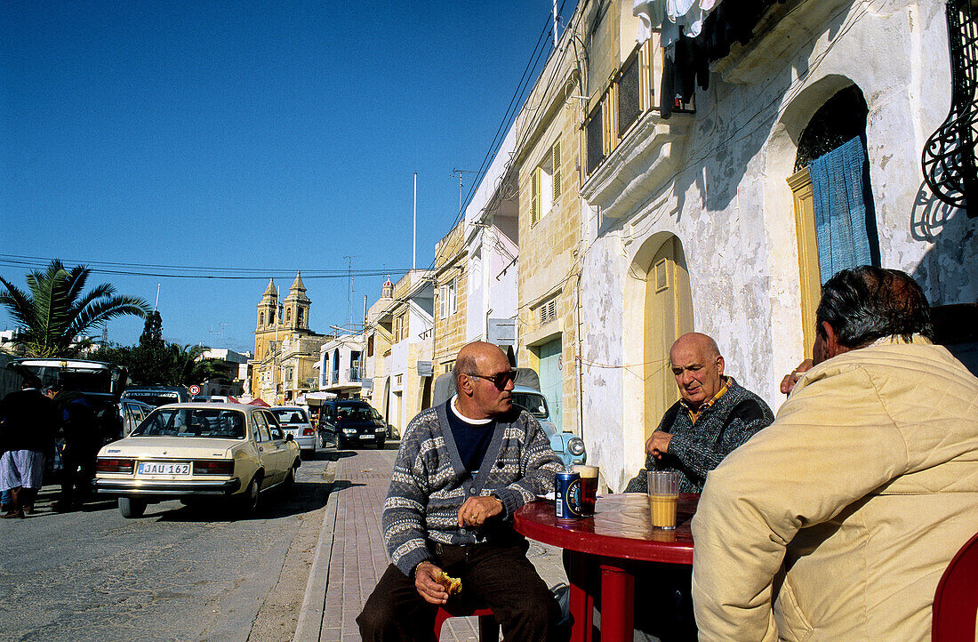 Café terrace on the Church Square. Marsaxlokk. Malta.