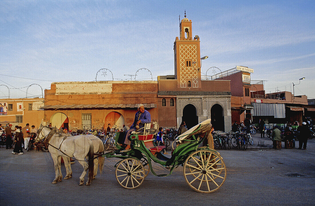 Barouche on the Jemaa El-Fna square, the liveliest place night and day in Marrakech. Morocco.
