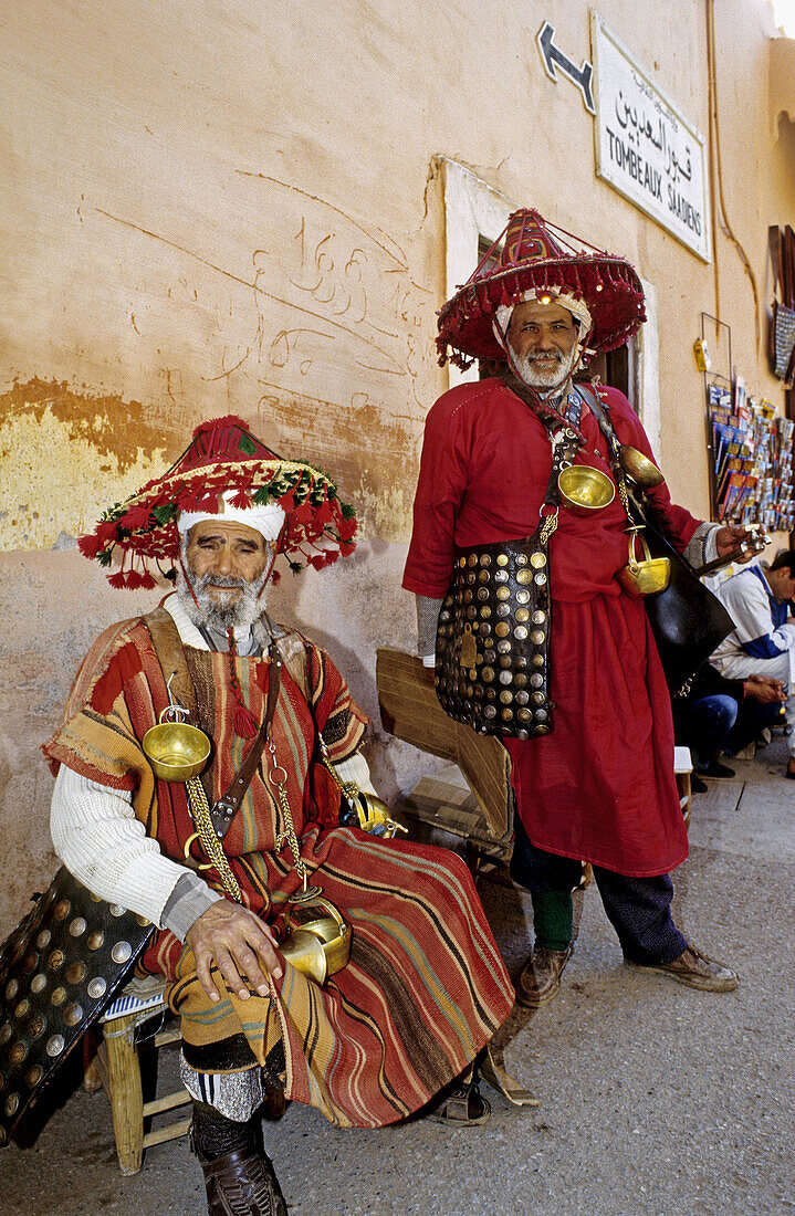 Jemaa El-Fna square water sellers in their traditional colourful costume. Marrakech. Morocco.