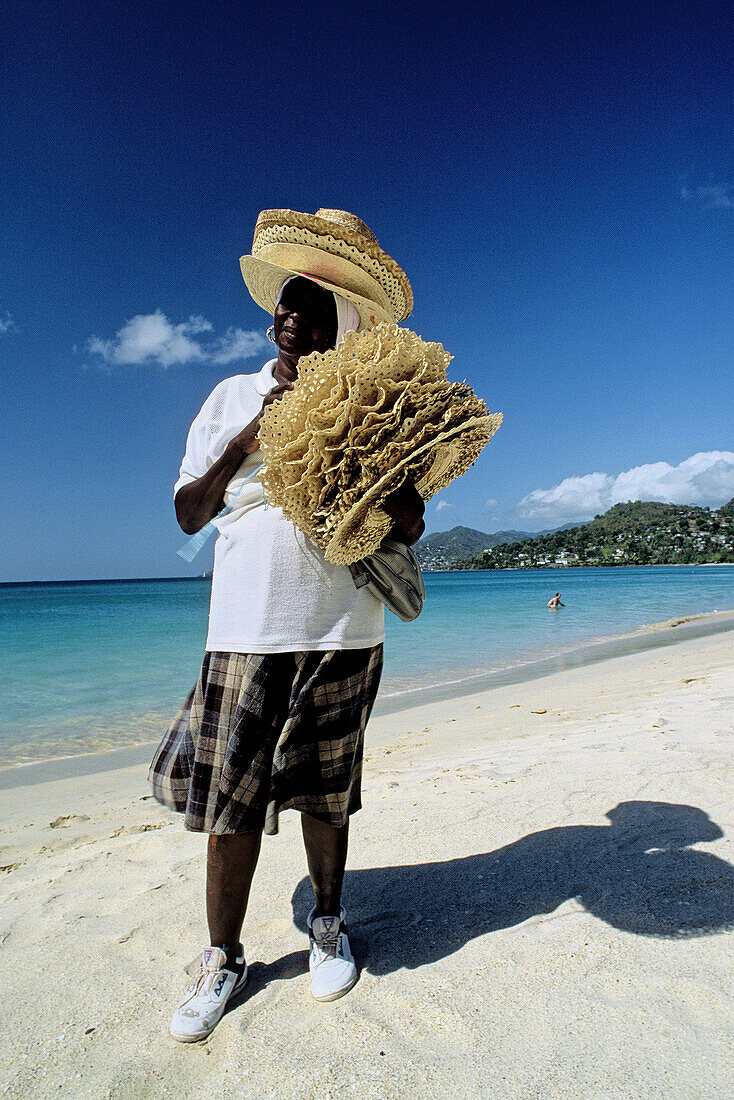 Woman selling straw hats. Grand Anse beach. Grenada, Caribbean