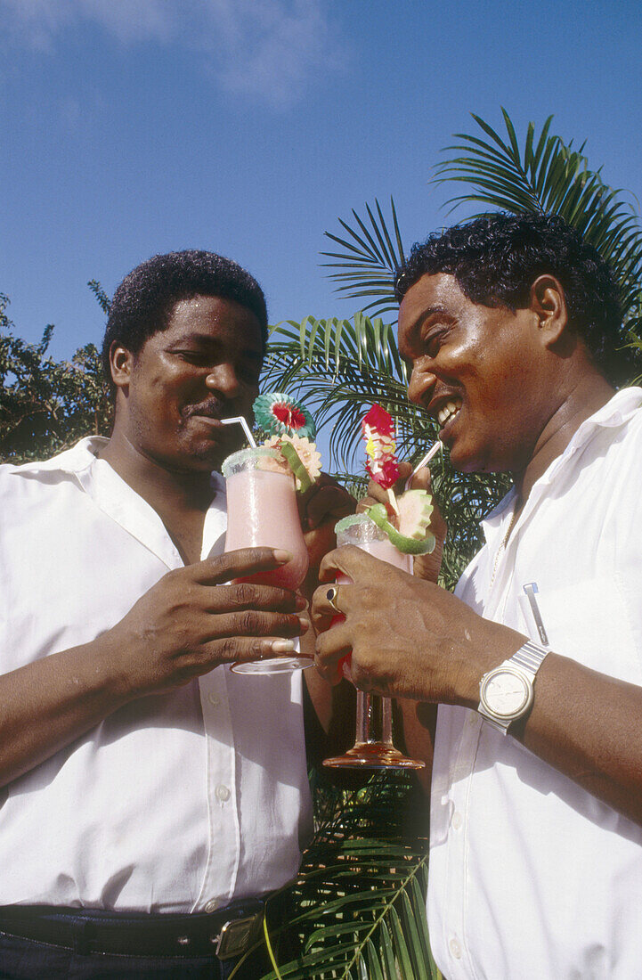 Local men drinking cocktails and having fun. Martinique, Caribbean, France
