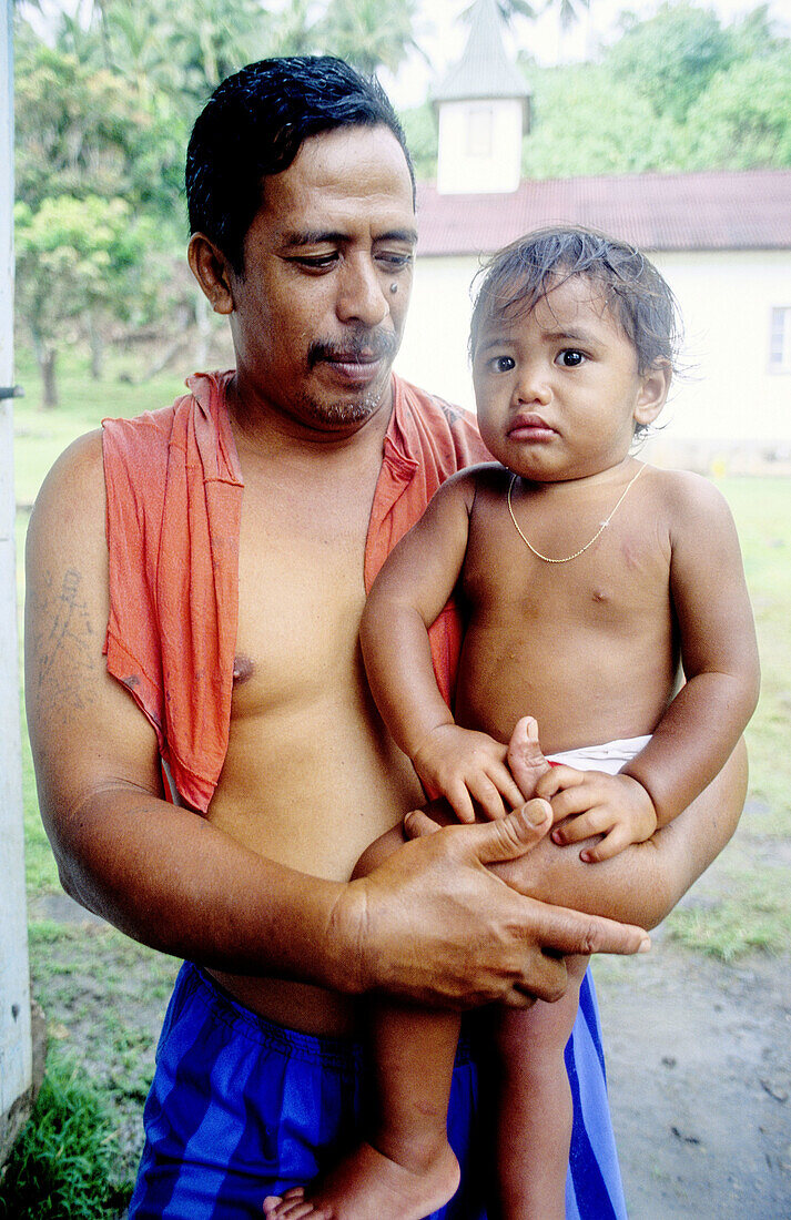 Father and son. Tahoata island. Marquesas archipelago. French Polynesia