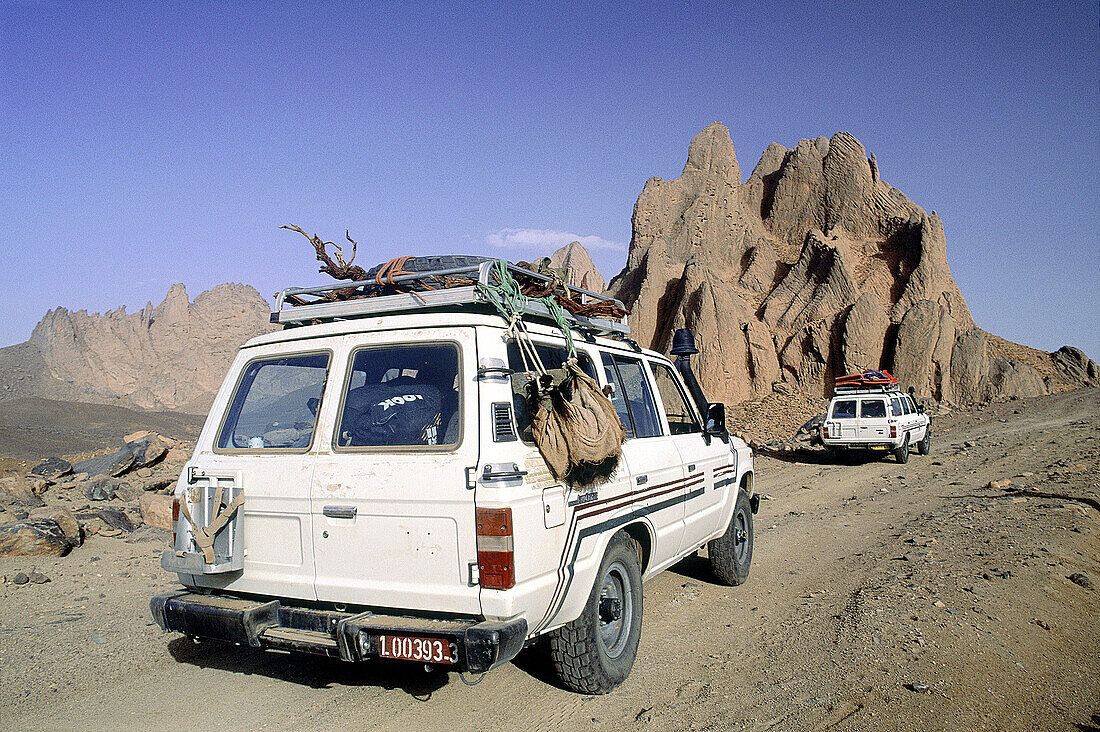 Four-wheel drive cars on the track. Atakor Mountains. Hoggar. Sahara. Algeria