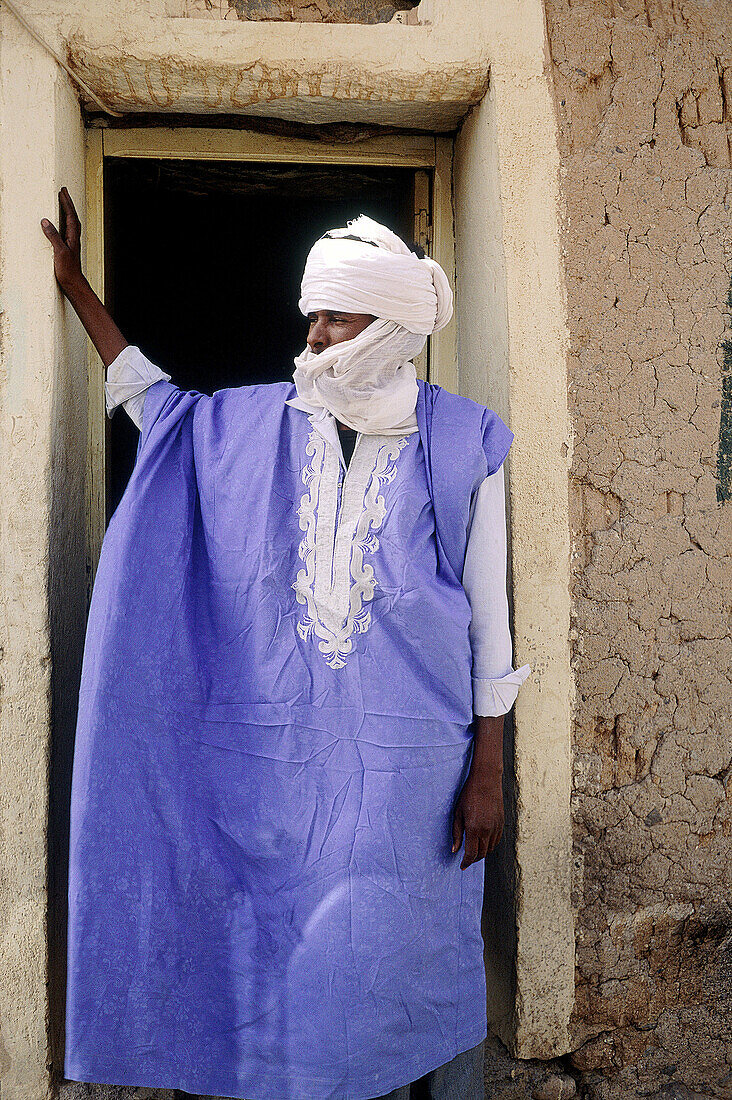 Tuareg men at his home door in the village of Ideles. Hoggar Mountains. Sahara. Algeria