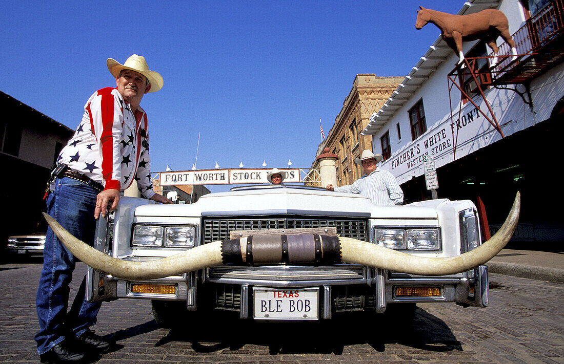 Cowboy and his customized car with cow horns. Fort Worth. Texas. USA