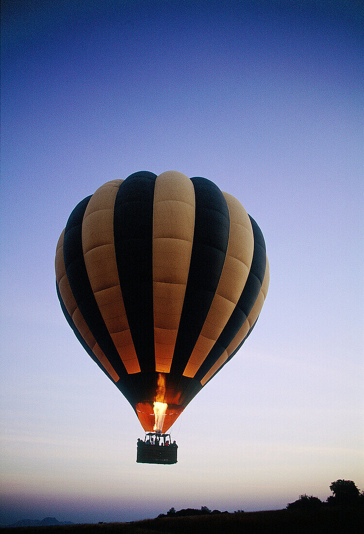 Balloon taking off at dawn. Serengeti NP. Tanzania