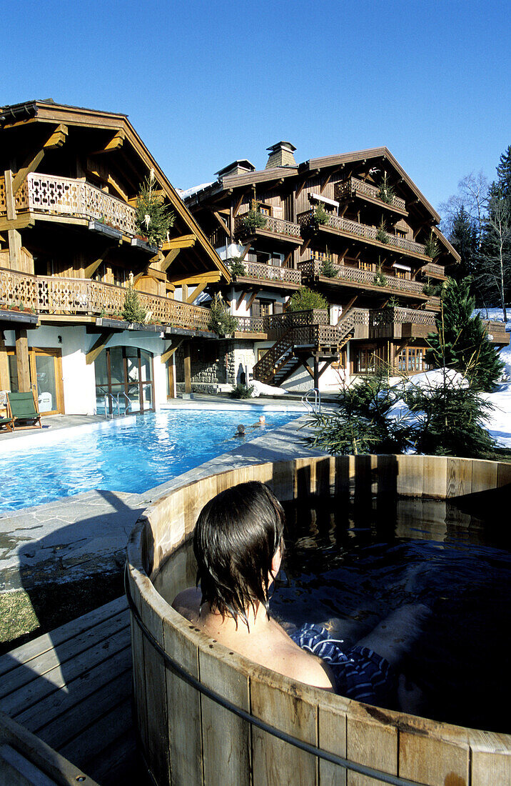 Outdoor swedish hot bath and swimming pool at Chalet du Mont d Arbois luxury hotel. Rothschild property. Megeve. Haute-Savoie. Alps. France