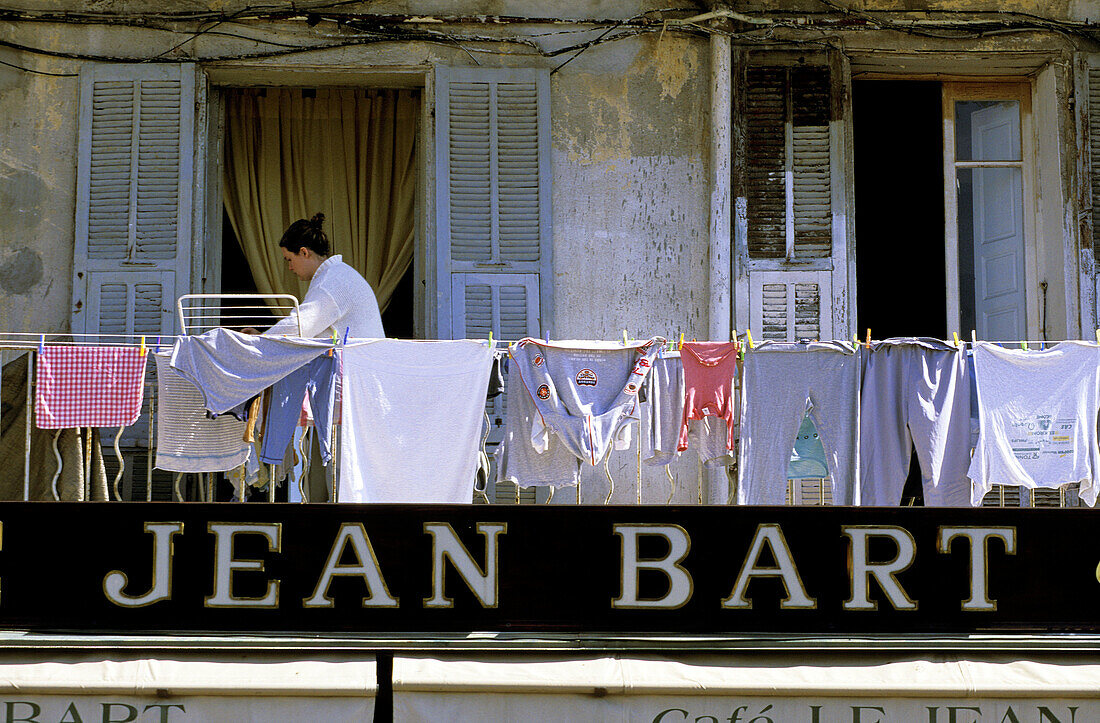 Drying laundry on a balcony above the café Jean Bart (a french pirate). Bastia. Haute-Corse. Corsica Island. France