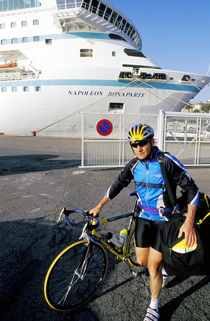 Bicyclist in front of ship at harbour. Bastia, Corsica Island. France