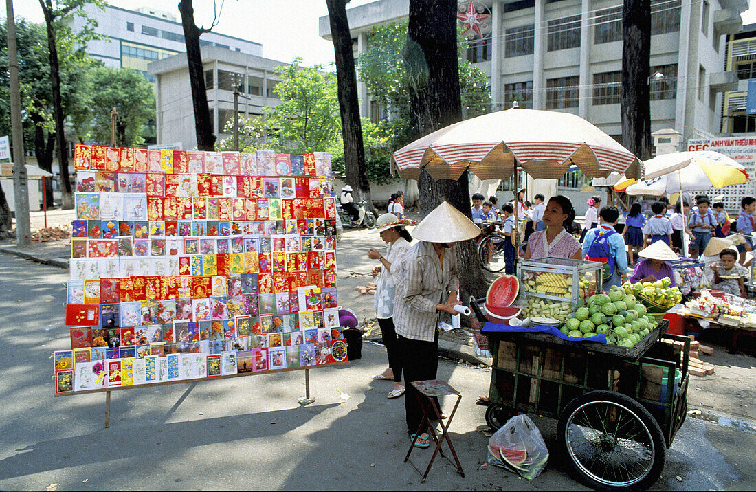 Selling Tete Festival special postcards and fruits in the sidewalk. Hanoi. Vietnam