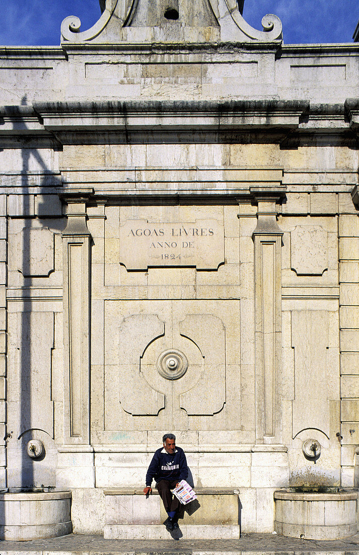 Man selling lottery tickets at a fountain. Lisbon. Portugal