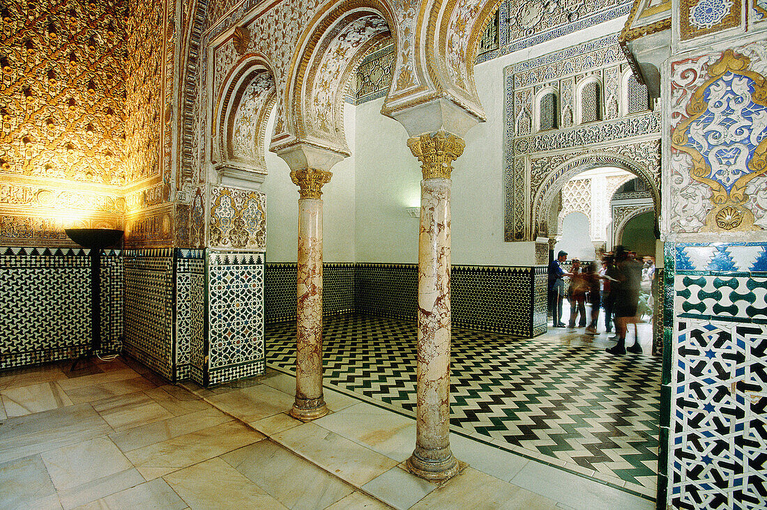 Tourists at the Almohad style rooms and courtyards of the Alcázar palace. Sevilla, Spain