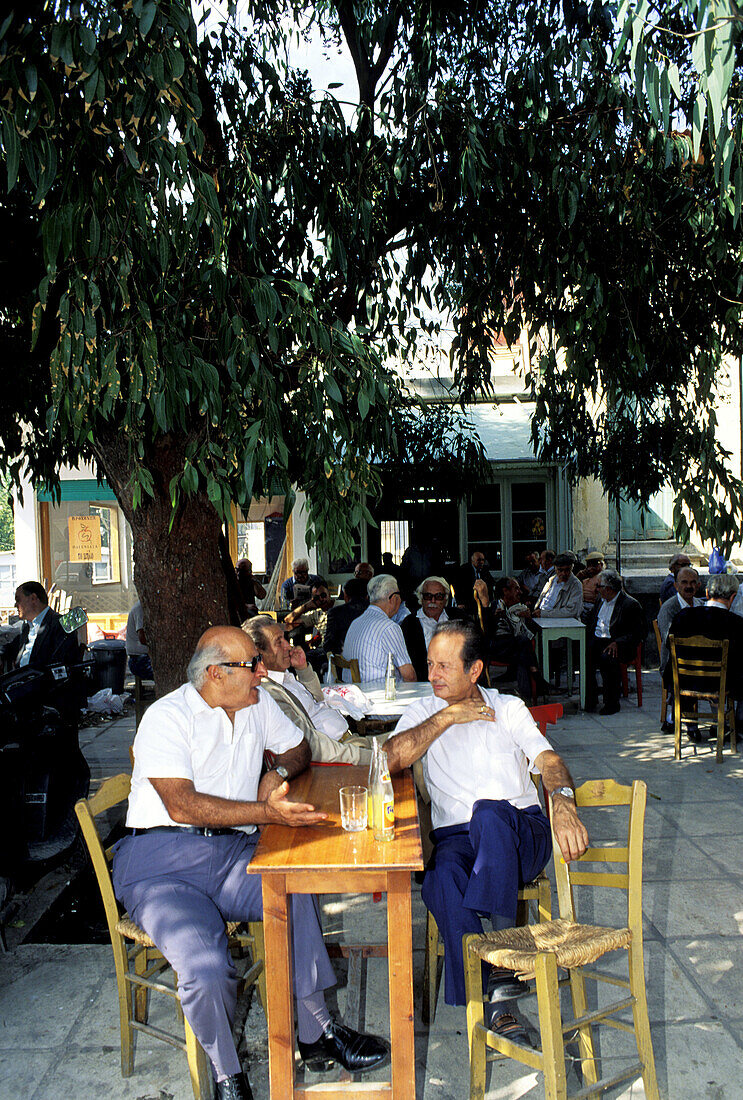 Two men chatting at outdoor cafe. Hania, Crete. Greece