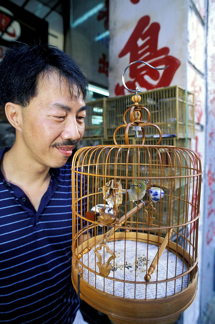 Bird lover with his pet. Kowloon, Hong Kong. China