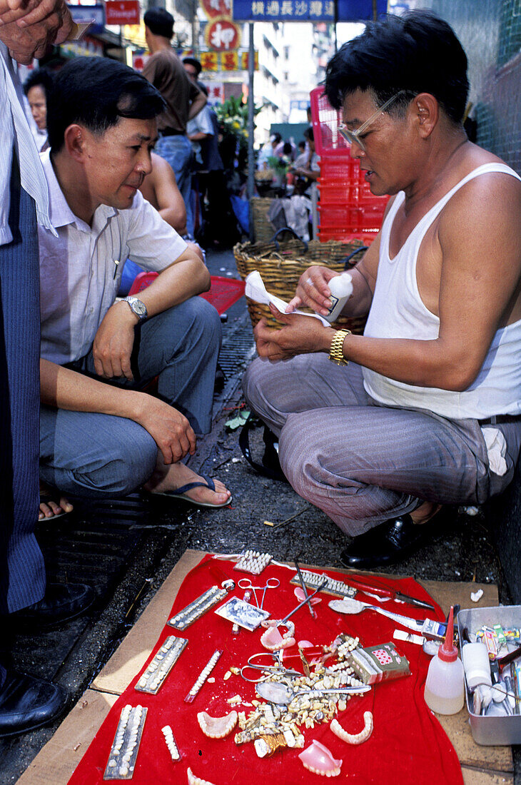 Dentist working in the street. Wanchai, Hong Kong. China
