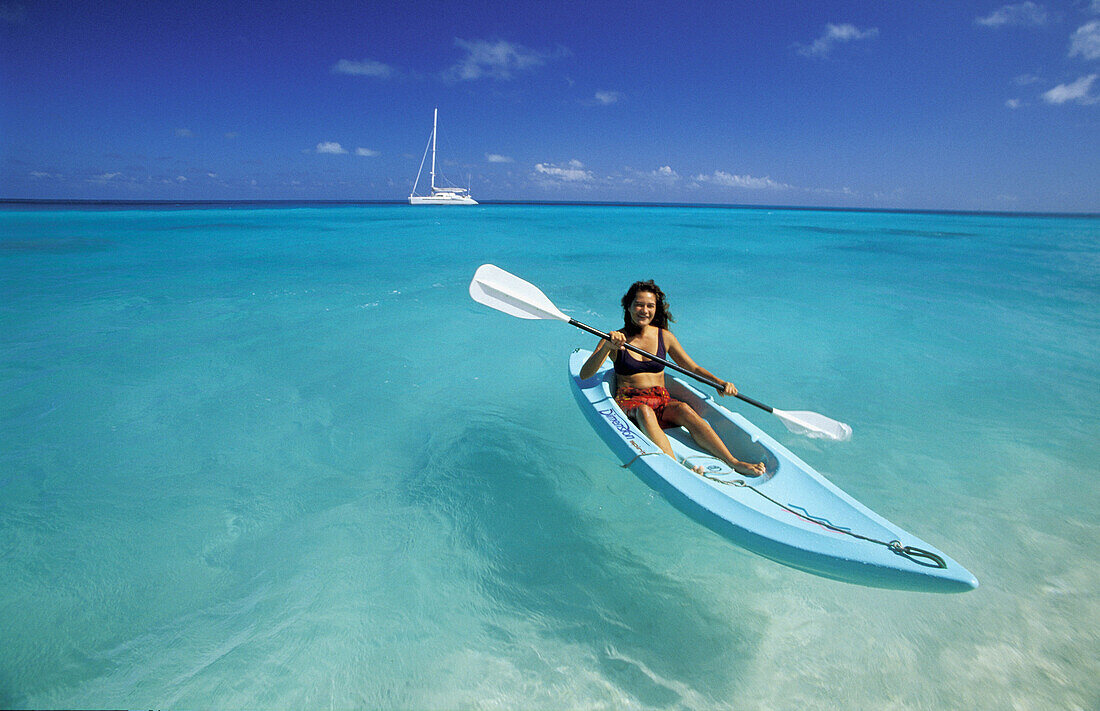 Woman canoeing. Tuamotu Islands. French Polynesia