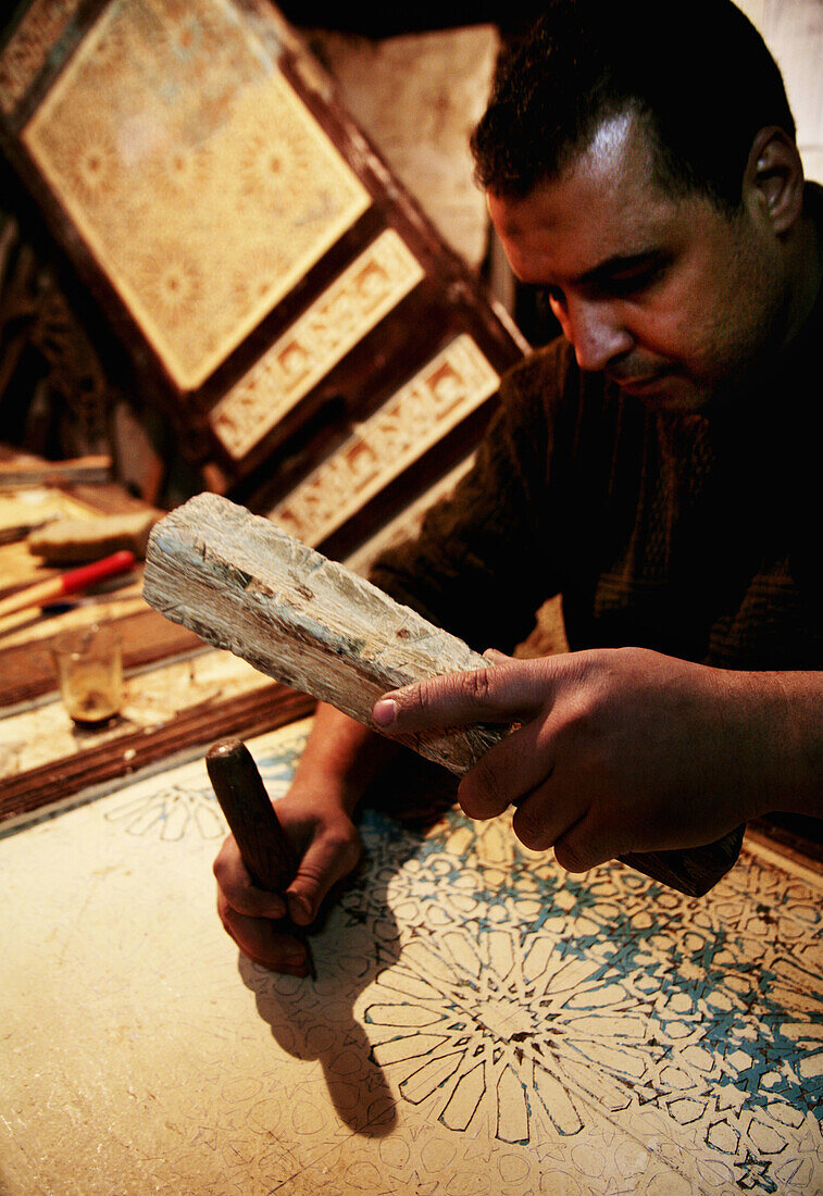 Mr. Mustafa Loulidi, carpenter on antic doors, in the Medina of Fes. Morocco.