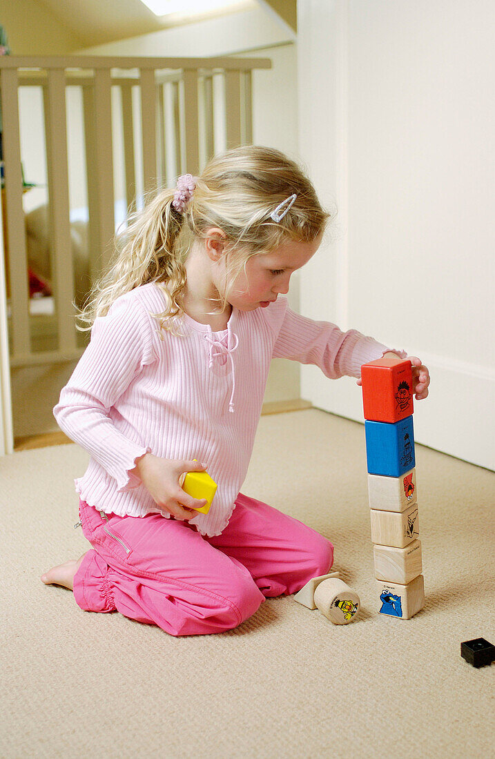  Children, Color, Colour, Contemporary, Cube, Cubes, Equilibrium, Female, Focus, Focused, Full-body, Full-length, Girl, Girls, Heap, Heaped, Home, Human, Indoor, Indoors, Infantile, Inside, Interior