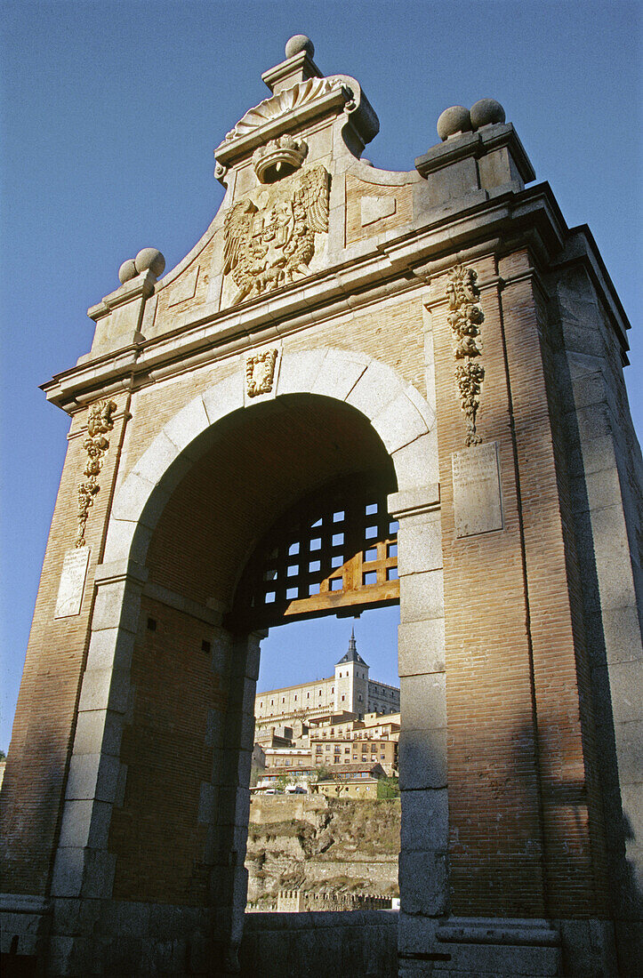 The Alcázar seen through an arch of the Alcántara Bridge. Toledo. Spain