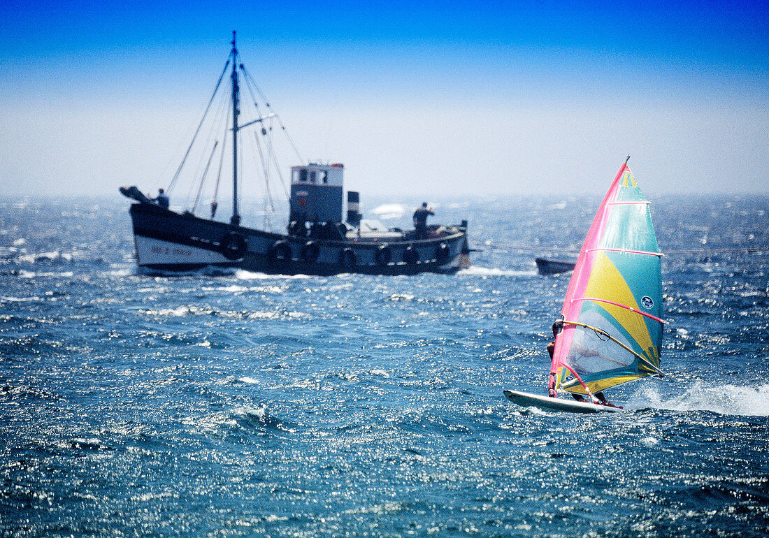 Windsurf and fishing boat at Costa de la Luz. Tarifa, Cádiz province. Spain