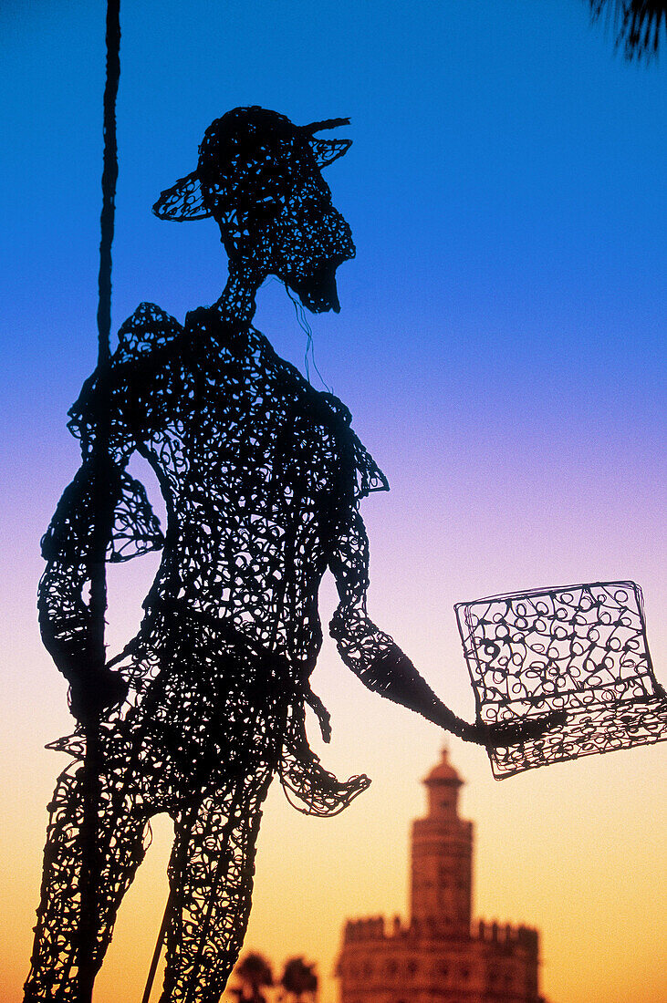 Don Quijote statua and Torre del Oro in background. Sevilla. Spain