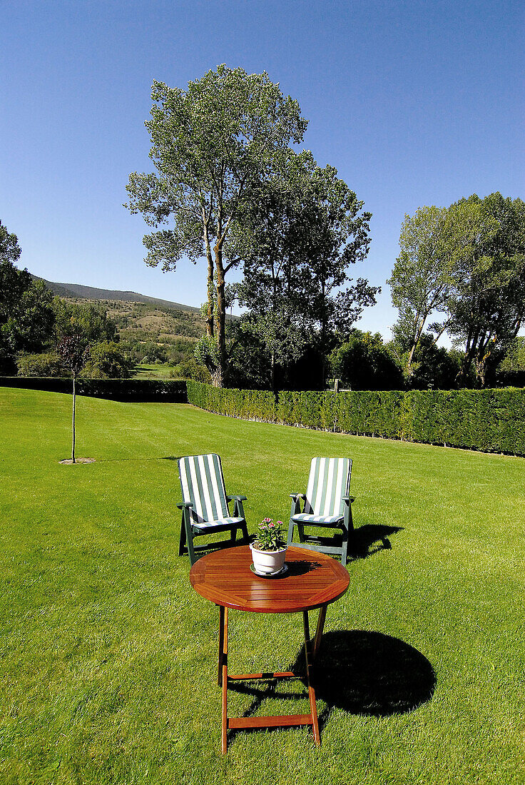 Table and loungers on grass. Osseja, Pyrénées-Orientales, France