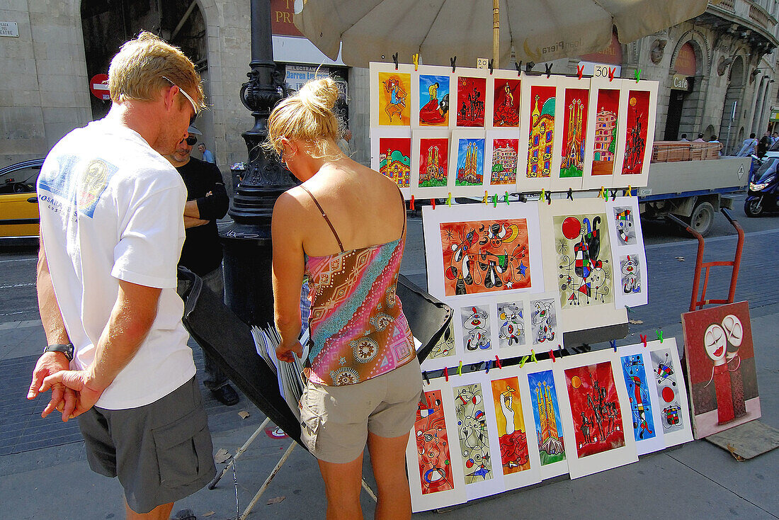 Tourists buying art. Las Ramblas. Barcelona. Spain.