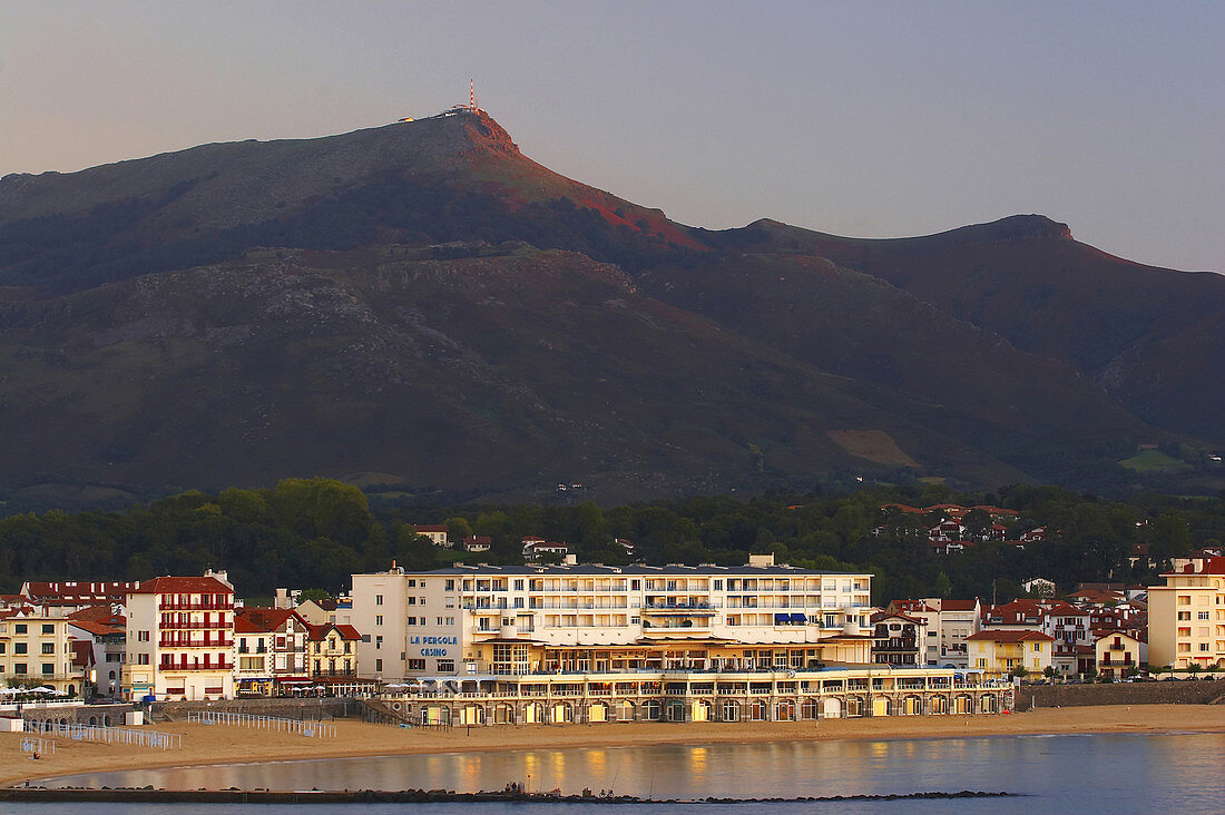 At sunset in the seaside resort St. Jean de Luz with Casino and view to La Rhune, Cote des Basques, dept Pyrénées-Atlantiques, France, Europe