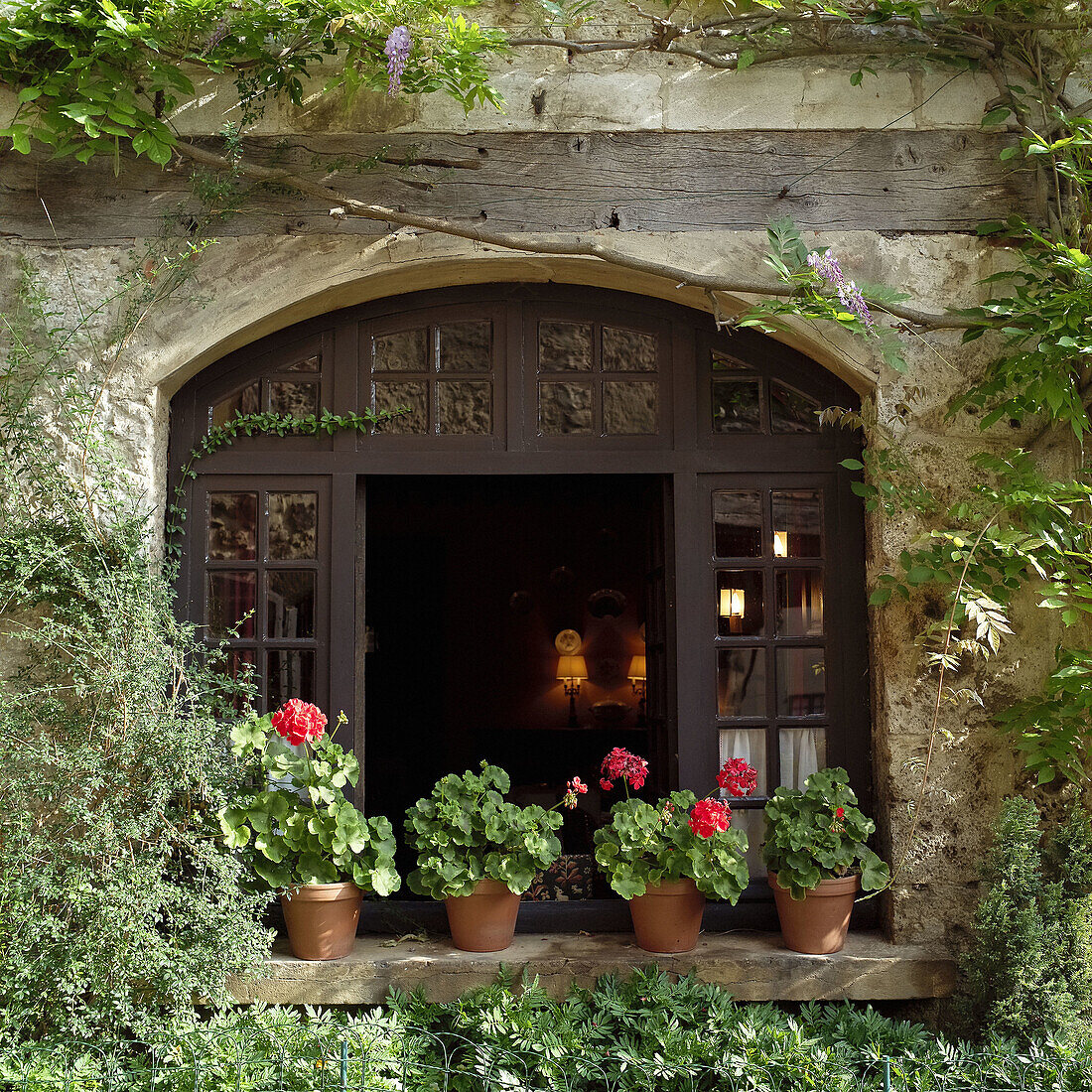 Restaurant window and flowers. Medieval city of Pérouges. Rhône Valley. France.