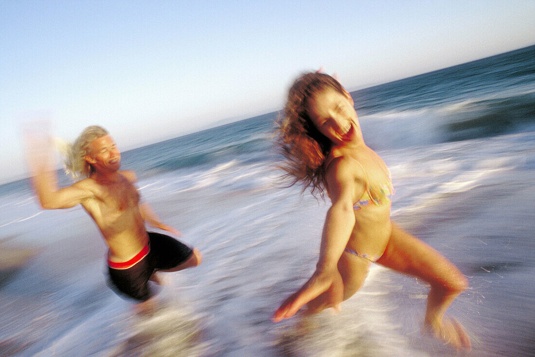  Action, Activity, Adult, Adults, Amusement, Bathing suit, Bathing suits, Beach, Beaches, Bikini, Bikinis, Blurred, Caucasian, Caucasians, Chase, Chasing, Coast, Coastal, Color, Colour, Contemporary, Couple, Couples, Daytime, Emotion, Emotions, Exterior, 