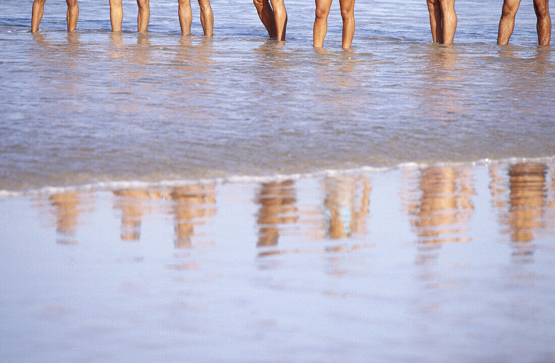  Adult, Adults, Anonymous, Barefeet, Barefoot, Beach, Beaches, Coast, Coastal, Color, Colour, Contemporary, Daytime, Exterior, Female, Holiday, Holidays, Horizontal, Human, Leg, Legs, Leisure, Line, Lines, Male, Man, Many, Men, Mirror image, Mirror images