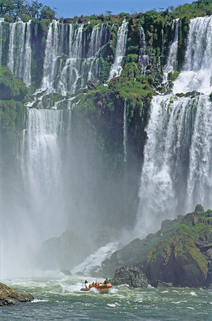 Rubber dinghies getting closer to the falls. Iguazu National Park. Misiones province. Argentina.