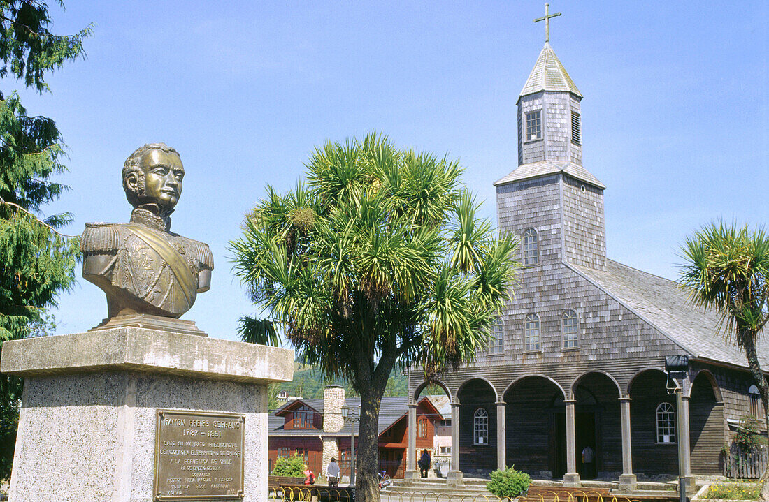 President Ramon Freire Serrano monument in front of Achao wooden church. Chiloé island. Chile.